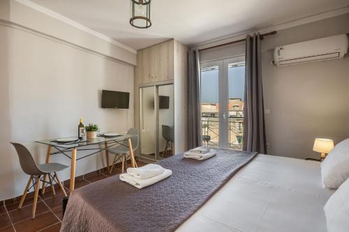 a bedroom with a bed with two towels on it at Fidias city rooms in Argostoli