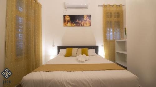 a bedroom with a bed with two stuffed animals on it at Aida Guest house in Nazareth