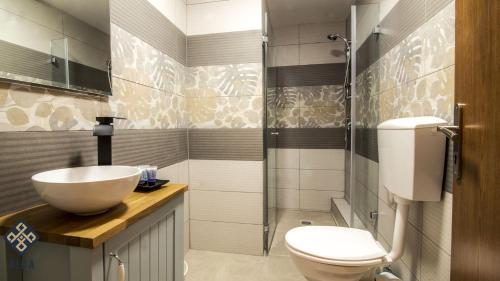 a bathroom with a sink and a toilet and a shower at Aida Guest house in Nazareth