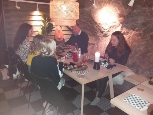 a group of people sitting at a table in a restaurant at Charming 1-Bed Apartment in Lulea in Luleå