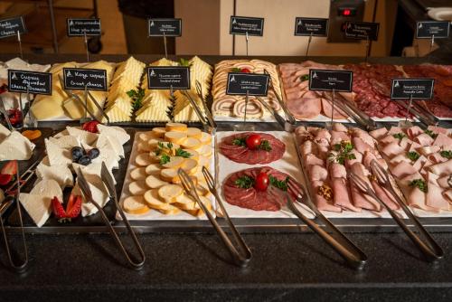 a display case with different types of meats and other foods at Hotel Arte SPA & Park in Velingrad
