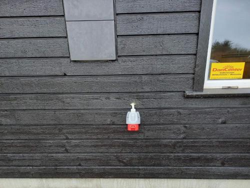 una botella sentada en el lateral de un edificio en 8 person holiday home in Hirtshals en Hirtshals