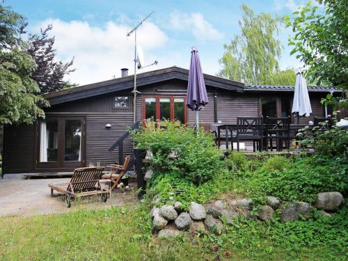 a house with two umbrellas in front of it at 8 person holiday home in Holb k in Holbæk