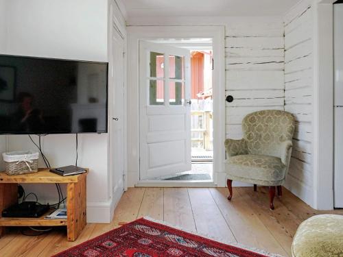 a living room with a chair and a television at 4 person holiday home in Mellösa in Mellösa