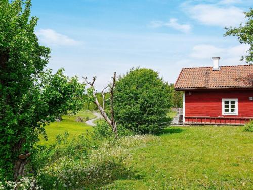 a red house in the middle of a field at 4 person holiday home in Mellösa in Mellösa