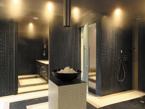 a bathroom with a sink and a shower with a bowl at Domaine De Manville in Les Baux-de-Provence