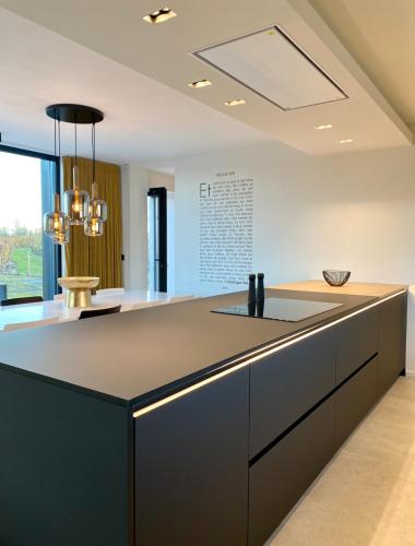 a kitchen with a large island with a counter top at Le Clos du Verger in Aubel
