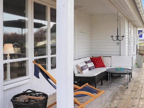 a porch with a couch and a table at 5 person holiday home in V r backa in Väröbacka