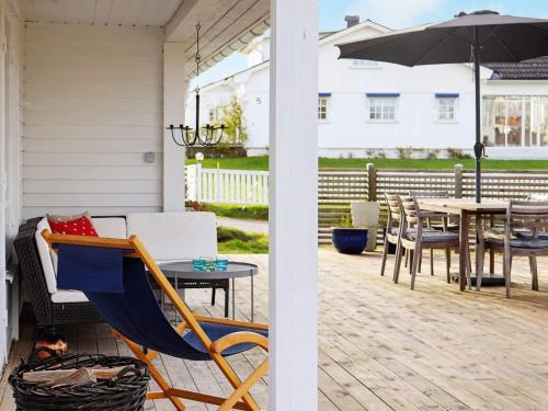 a porch with a hammock and a table with an umbrella at 5 person holiday home in V r backa in Väröbacka