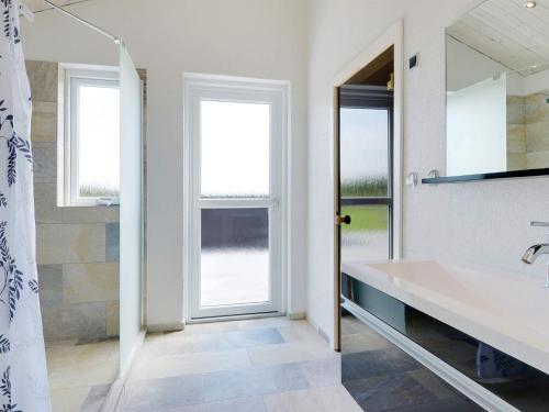 a bathroom with a large sink and a mirror at 16 person holiday home in Ansager-By Traum in Ansager