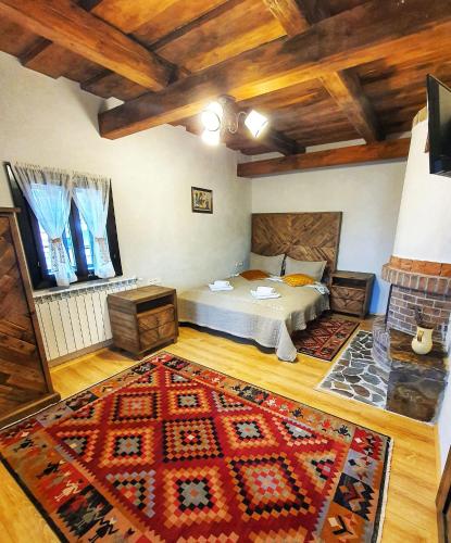 a bedroom with a bed and a rug on the floor at Vatra Boiereasca in Cacica