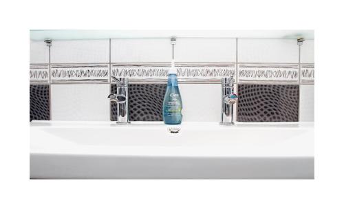 a bathroom sink with a blue bottle on it at Sarajevo Apartments No.5 in Sarajevo