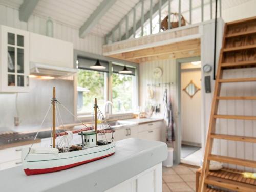 a toy boat sitting on a counter in a kitchen at 6 person holiday home in Roslev in Roslev