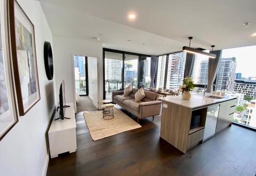 a living room with a couch and a table at Southbank Apartment with pool Brisbane CBD Hosted by Homestayz in Brisbane