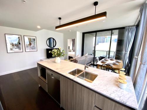 a kitchen with a sink and a counter top at Luxury Southbank Apartment with pool Brisbane CBD Hosted by Homestayz in Brisbane