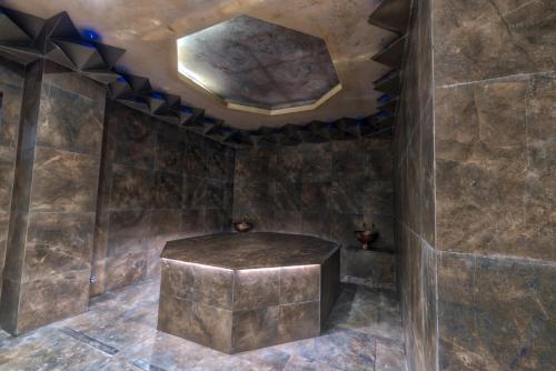 a room with a stone stool in a room with a ceiling at Hotel Arte SPA & Park in Velingrad