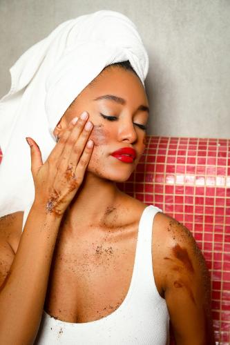 a woman with a towel on her head with her hand on her face at Hotel Arte SPA & Park in Velingrad
