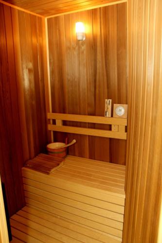 a small sauna with a wooden floor and a light at Arena Hotel Sheki in Sheki