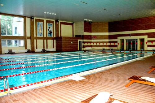 a large swimming pool in a large room at Arena Hotel Sheki in Sheki