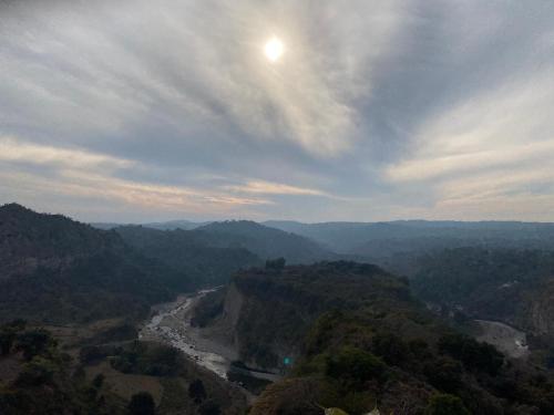 a view of a river in the middle of a valley at Hotel Victoriya Palace,Mcleod Ganj in McLeod Ganj