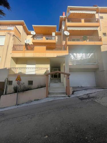 an apartment building with a staircase in front of it at The Teal Studio in Kozani in Kozani