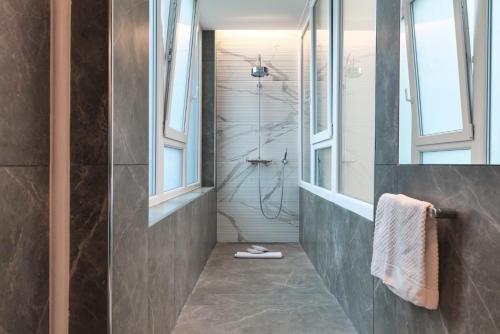 a bathroom with a shower with a glass door at Contempora Apartments - Turati 3 One Bedroom Apartment in Milan