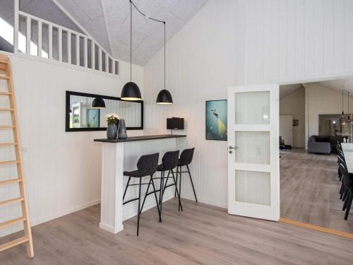 a room with a bar with chairs and a table at Luxury Retreat by the Sea - By Traum Ferienwohnungen in Sarup