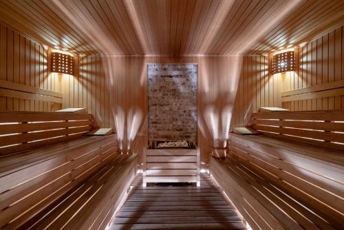 an empty sauna with wooden benches and curtains at Mövenpick Resort Antalya Tekirova - Ultra All Inclusive in Tekirova