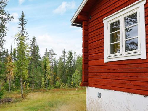 a red house with a window on the side of it at 7 person holiday home in S LEN in Sälen