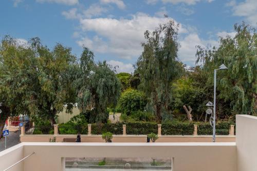 a view of a park with trees in the background at Kipos Hotel in Rethymno Town