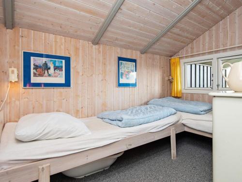 two bunk beds in a room with wooden walls at 6 person holiday home in Børkop-By Traum in Børkop