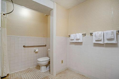 a bathroom with a toilet and towels at Quality Inn Fredericksburg near Historic Downtown in Fredericksburg