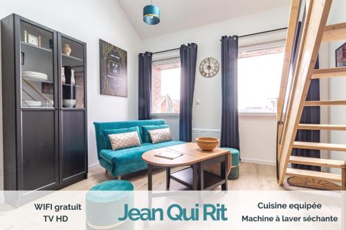 ein Wohnzimmer mit einem blauen Sofa und einem Tisch in der Unterkunft KASA du Moulin - Cosy et au calme in Saint-Quentin