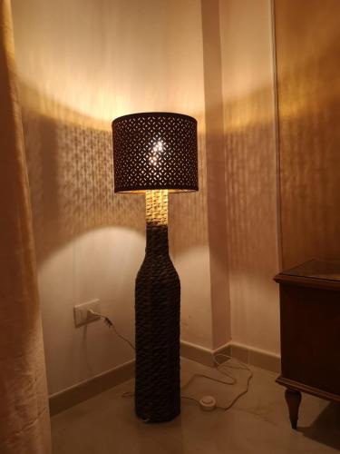 a black lamp with a shade on top of a room at Le 3 Dee in Reggio Calabria