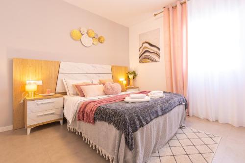 a bedroom with a bed and a table with towels on it at PÌSO MAR ALTEA in Altea