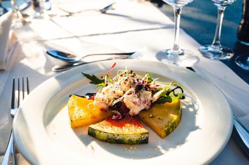 a white plate with food on a table at Schloss Freudenfels in Eschenz