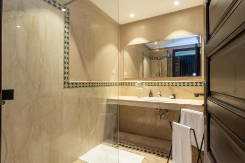 a bathroom with a sink and a mirror at The Levantine in Marrakesh