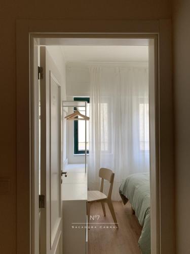 a bedroom with a desk and a bed and a chair at Nº7 Sacadura Cabral in Guarda