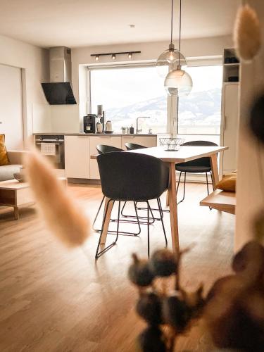 a kitchen and dining room with a table and chairs at PAM Apartments in Kaprun