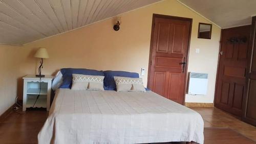 1 dormitorio con 1 cama grande y suelo de madera en Location Cap corse, en Canari