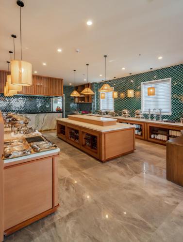 a large kitchen with wooden counter tops and green tiles at The Tahiti Beach Hotel in Phu Quoc