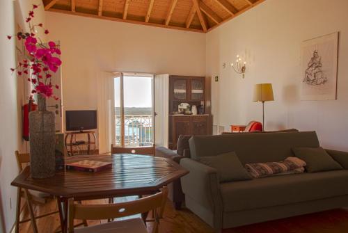 a living room with a couch and a table at Casa Viana - Guesthouse in Cabanas de Tavira