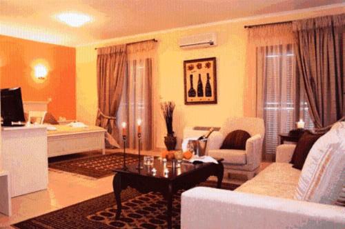 a living room with a couch and a table at Asteras Hotel in Naousa Imathias