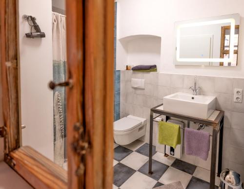 a bathroom with a sink and a toilet at Pension Onkel Ernst in Naumburg