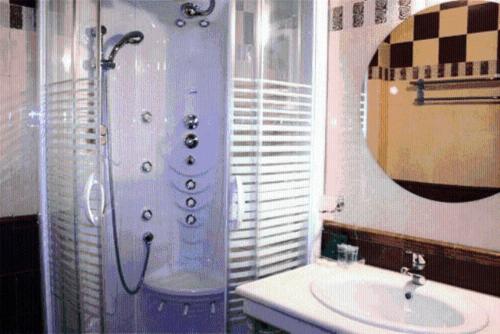 a bathroom with a shower and a sink and a mirror at Asteras Hotel in Naousa Imathias