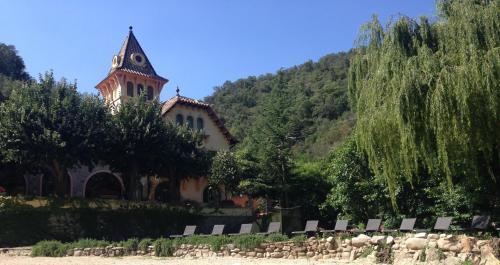 a building with a tower with a clock on it at Hotel Spa La Central - Adults Only in Maçanet de Cabrenys