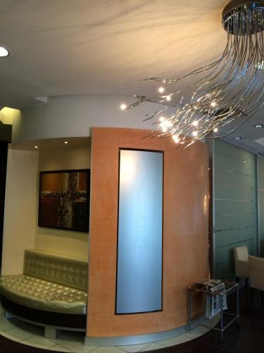 a room with a bench and a chandelier at Millennhotel in Bologna