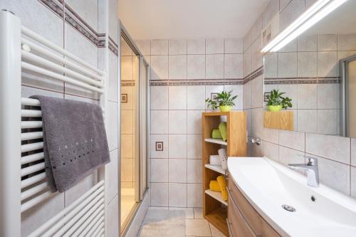 a bathroom with a sink and a tub and a mirror at Landhaus Nagl in Altenmarkt im Pongau