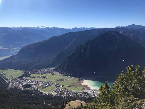 a view of a town in the middle of a mountain at Urban Alpine Penthouse with Lake View in Maurach