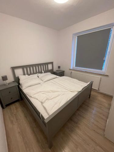 a bedroom with a bed and a large window at strandnahe 3-Zimmer Wohnung direkt am Yachthafen in Kiel